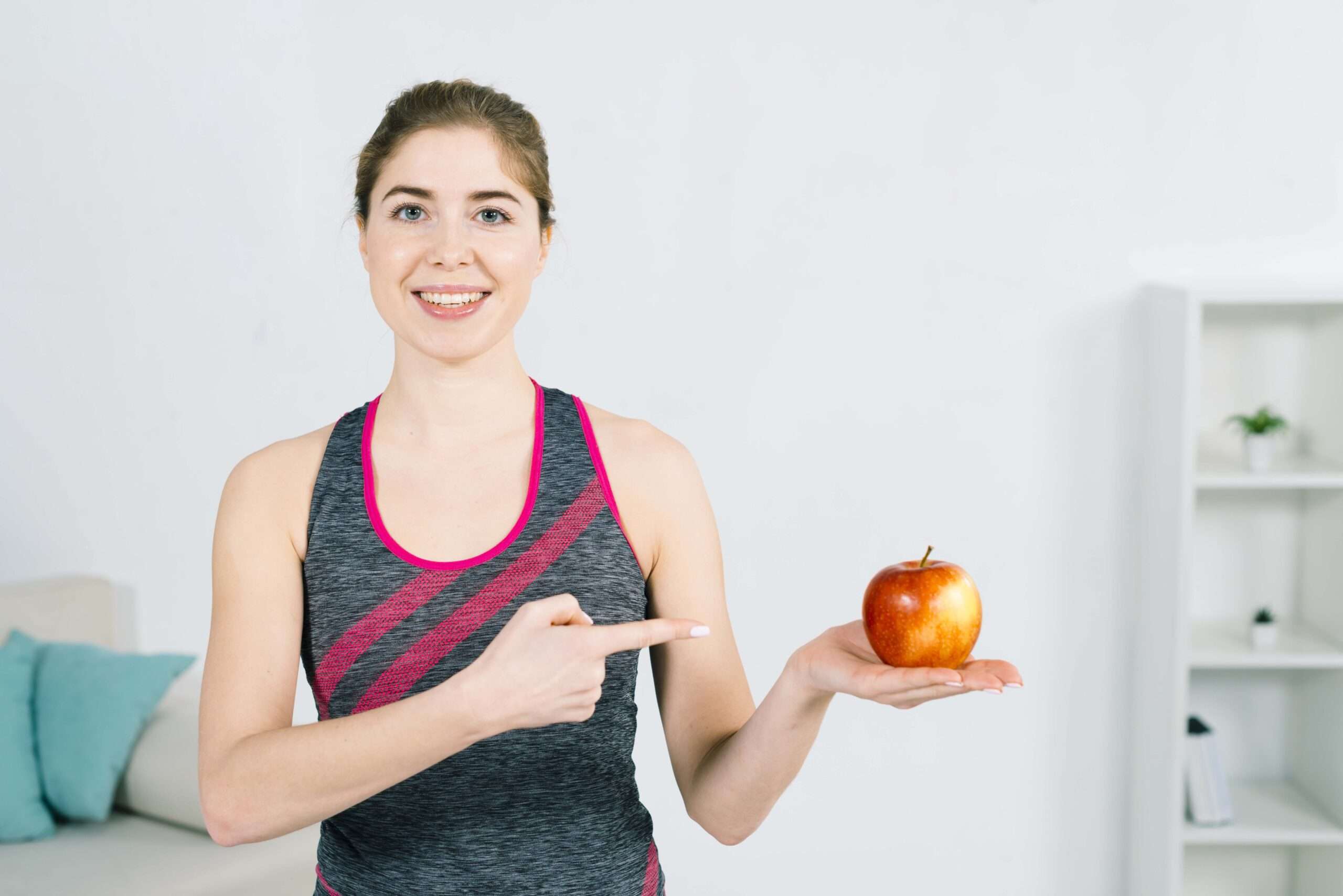 portrait-happy-young-fitness-woman-showing-red-apple-hand How do you prevent haemorrhoids or piles