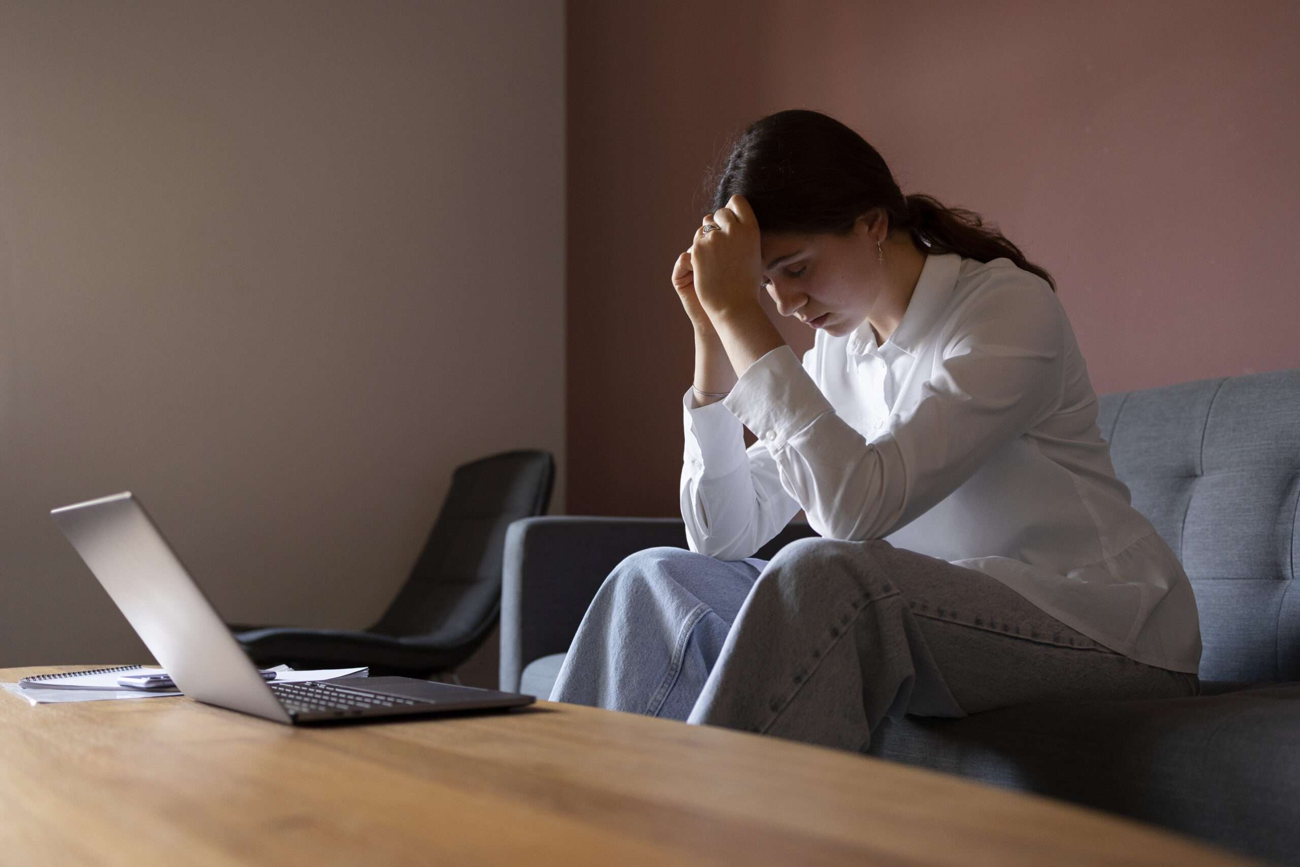 woman-sitting-couch-side-view Can Anxiety Cause Arm Pain