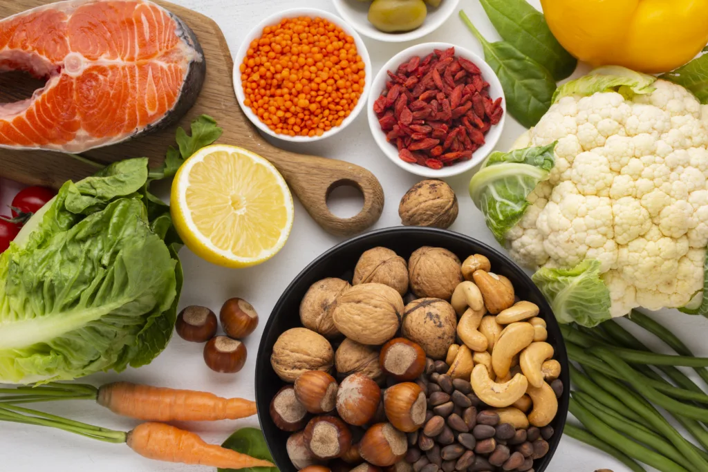Top view of natural healthy foods like nuts, fish, citrus, and leafy greens – perfect visual for natural remedies for allergies in kids through diet.